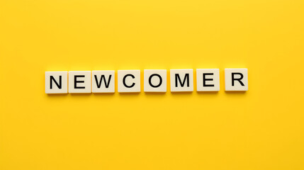 Newcomer Word on Letter Tiles on Yellow Background. Minimal Aesthetics.