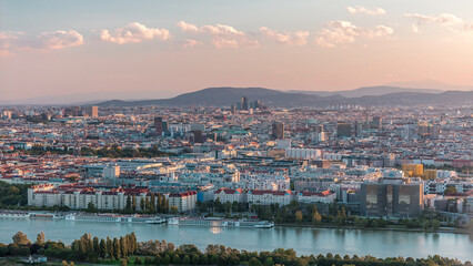 Aerial panoramic view of Vienna city with skyscrapers, historic buildings and a riverside promenade timelapse in Austria.