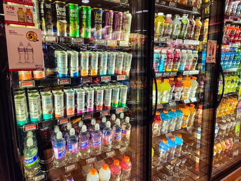 Refrigerated coolers full of sparkling water and sports drinks brands in a Minnesota convenience store (May 2025)