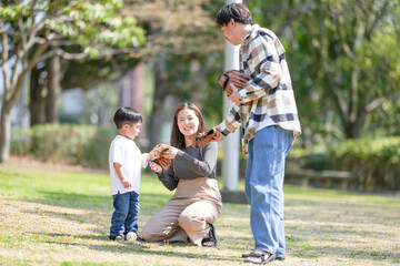 One bright March morning at a beautiful forest-rich park in Japan, a 3-year-old Japanese boy along with his thirtysomething parents are about to enjoy a game of catch with baseball gloves and a ball.
