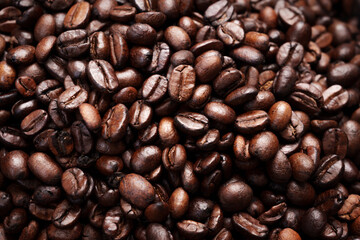 Close-up of roasted brown coffee beans piled together, showcasing rich texture, aroma, and freshness on a white studio background.