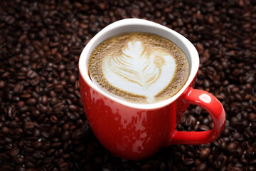 Freshly brewed black coffee in a white cup beside roasted beans on rustic table, capturing morning aroma, warmth, and cozy atmosphere.