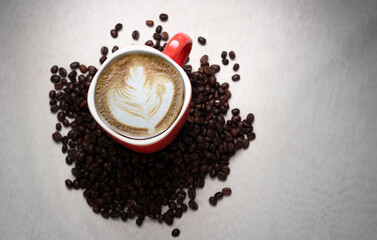 Freshly brewed black coffee in a white cup beside roasted beans on rustic table, capturing morning aroma, warmth, and cozy atmosphere.