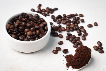 Close-up of roasted brown coffee beans piled together, showcasing rich texture, aroma, and freshness on a white studio background.