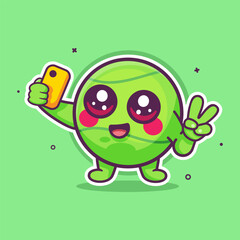 happy tennis ball character mascot taking a selfie with a smartphone isolated cartoon 