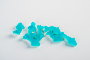Obraz premium Jelly fish candies. Gummy shark, blue dolphin jelly coated with sugar on a white background.