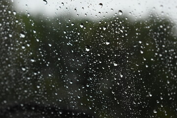 water drop on mirror in rainy day, blur natural background