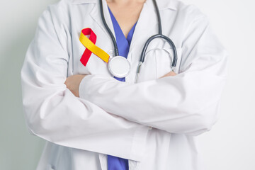 World hepatitis day awareness month, 28 July. Doctor holding Red and Yellow ribbon. Liver cancer,...