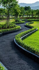 Obraz premium Long winding garden pathway with neatly trimmed bushes and lush green trees in a scenic park setting with mountains in the background under clear blue sky