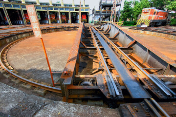 A historic railway roundhouse in Changhua, Taiwan, featuring locomotives on multiple tracks.