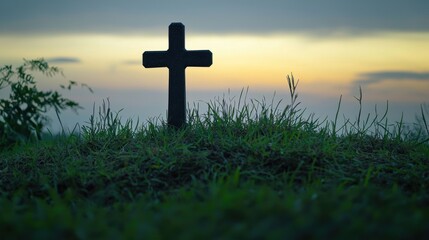 Sunset over a peaceful landscape with a solitary cross monument on grassy hilltop du evening twilight with dramatic sky and serene atmosphere