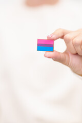 Bisexuality Celebrate Day and LGBT pride month, LGBTQ or LGBTQIA concept. Hand holding purple, pink and blue flag shape for Lesbian, Gay, Bisexual, Transgender, Queer, Pansexual, Marriage Equality Law