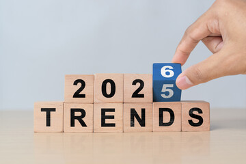 Hand flipping wooden cube from 2025 to 2026. New year concept for business, fashion, and technology trend changes and future planning