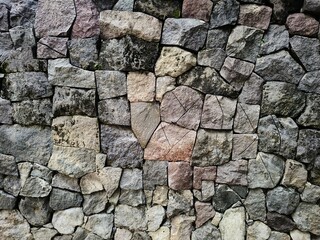 Stack of neatly arranged rocks, textured stone background
