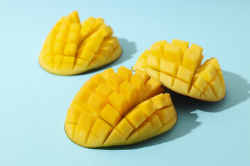 Ripe sliced mango on a blue background