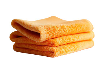 Three neatly folded, pale orange microfiber cloths, soft and plush, stacked atop one another