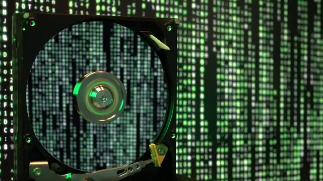 Computer hard disk on green moving background. The information is read, written to the information medium.