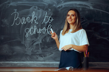 Cheerful Professor Welcoming Kids Back to School in new Semester. Friendly teacher writing on a blackboard a warm greeting message
