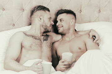 Young attractive couple relaxing on bed at home.