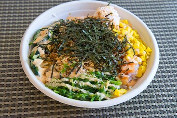 Poke Bowl with salmon, seaweed, corn and sauce