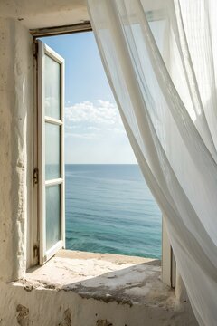 Fototapeta Open white window with light curtain flowing in the breeze, offering a peaceful view of calm blue sea and sky, perfect summer day on the Mediterranean coast