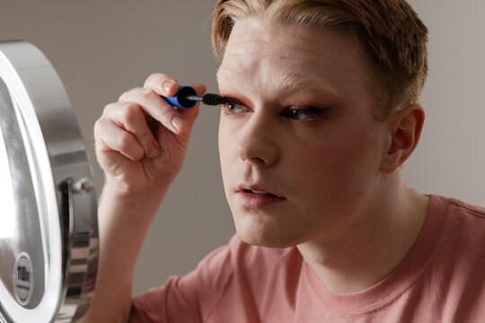 Young Man Applying Mascara Makeup Routine Beauty Closeup
A young man applies mascara while looking into a round LED mirror during his personal makeup routine. Shot indoors in natural lighting. - Powered by Adobe