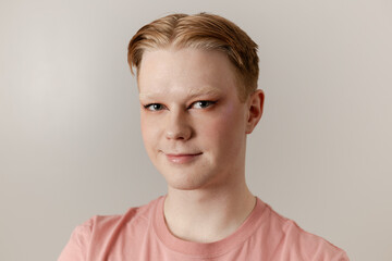 A Close-up Portrait of Man with Makeup and Confident Expression
A close-up portrait of a young man...