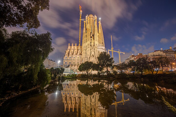 The illuminated Nativity Facade of the famous Sagrada Familia in Barcelona at blue hour