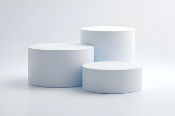 Minimalist studio shot featuring three white cylindrical pedestals of varying heights arranged on a pristine white background.