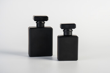 Perfume in beautiful black bottle, isolated on white background.