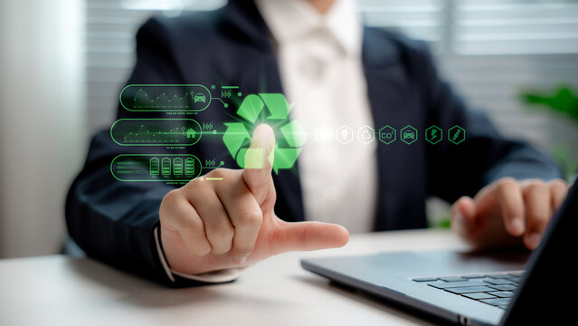 Businessperson interacting with recycling icon on virtual interface, representing green technology, eco-friendly data, sustainable energy, and digital transformation for environmental responsibility.
