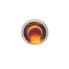 Amber liquid in a round glass, viewed from directly above, showing reflections and subtle texture