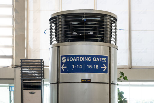 Blue information board showing travelers the way to the boarding gates at daytime inside the airport for domestic flights of Ninoy Aquino International Airport in Manila.