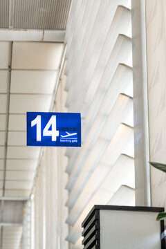 Blue information board showing travelers the way to the boarding gates at daytime inside the airport for domestic flights of Ninoy Aquino International Airport in Manila.