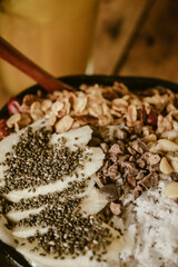 Close up of a delicious healthy smootie bowl served in a coconut with chia seed, bananas, coconut...