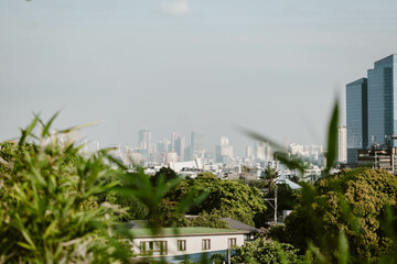 Stunning cityscape of the skyline of Manila outdoor at daytime on a hazy morning on the roof of a hotel during a holiday in the Philippines in South East Asia with space for text.
