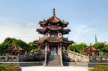Cuiheng Pavilion, a multi-tier landmark in 228 Peace Memorial Park, Taipei, Taiwan, towers above broad stone staircases with red pillars, sweeping tiled roofs, and dragon-tipped eaves, all framed by