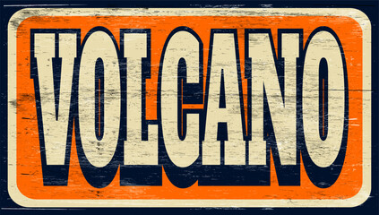 Aged and worn volcano sign on wood