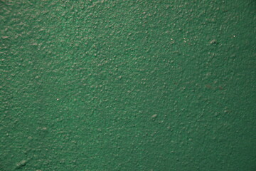 Close-up of textured green paint. Abstract, versatile background. Use for designs, overlays, posters, or backgrounds.
