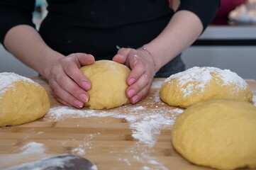 Midsection of woman preparing dough for bread at home