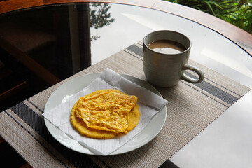 Typical Costa Rican breakfast: tortilla with egg and a glass of coffee or torta de huevo con tortilla