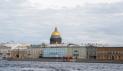 Picturesque Waterfront View of St. Petersburg Showcasing Historic Architecture and the Iconic Golden Dome Under a Cloudy Sky