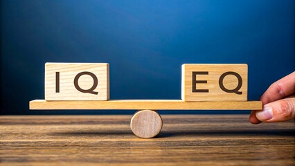 Wooden blocks showing iq and eq on seesaw symbolizing intelligence versus emotional quotient comparison
