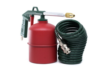 Green and Red Metal Tool with Coiled Hose on a White Background