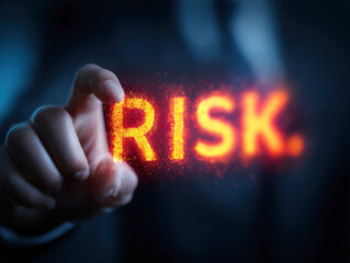 Concept of risk illustrated with glowing text by a person in a suit