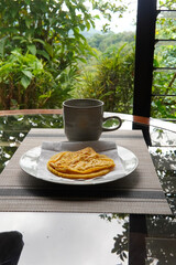 Typical Costa Rican breakfast: tortilla with egg and a glass of coffee or torta de huevo con tortilla