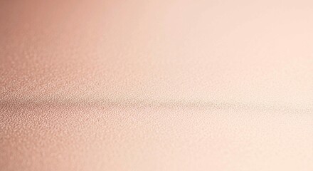 Subtle metallic rose gold background with a fine texture and soft light, perfect for luxury designs.
