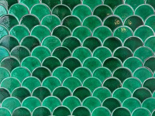 Fototapeta premium Texture of Japanese fish scales or Chinese fish skin wave and curve pattern. Asian curved fan and fish scales pattern, in green and tosca color. Seamless background texture.