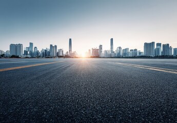 Empty asphalt road leading to the modern city skyline of Shenzhen, China, at sunrise, offering a panoramic view of urban landscape