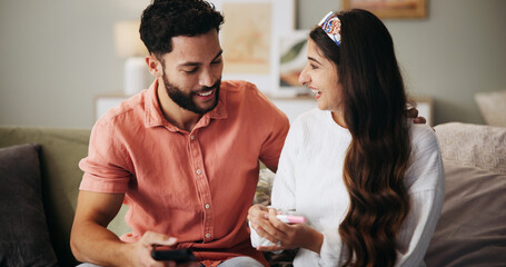 Couple, phone and happy on sofa with pregnancy test, results and excited with fertility in home. People, man and woman with stick, smile and good news for baby, success and love with support at house